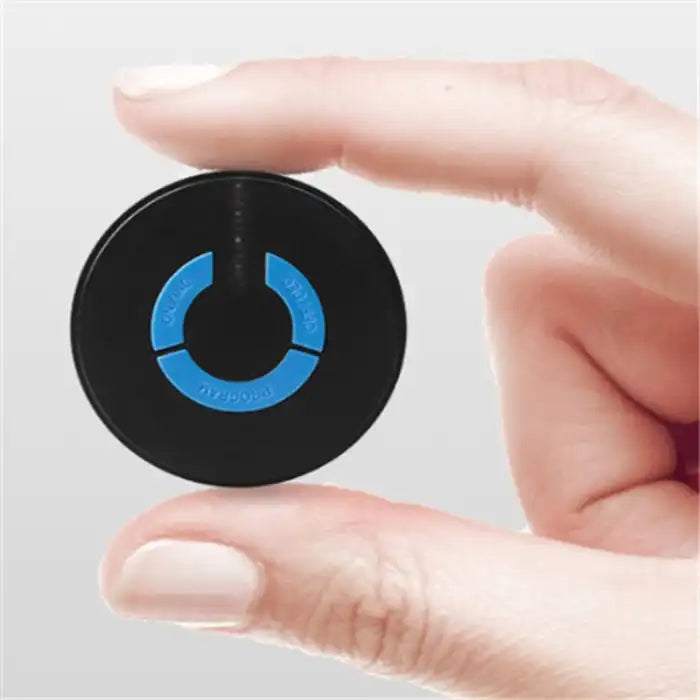 .Apple CarPlay massage controller shown between fingers to highlight compact and portable device size.