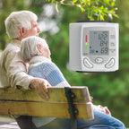Blood pressure tester shown near elderly couple on bench promoting senior health awareness.
