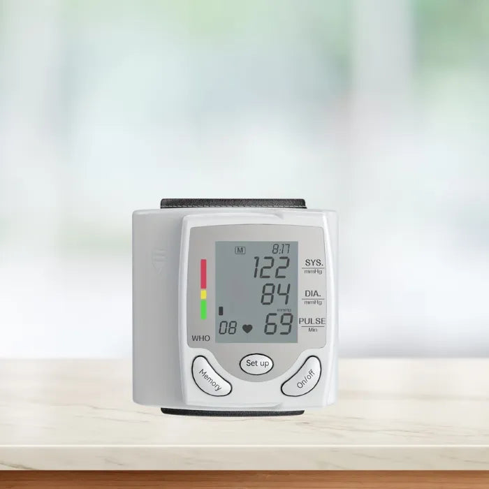 Front view of wrist blood pressure tester with digital screen showing systolic, diastolic, and pulse.