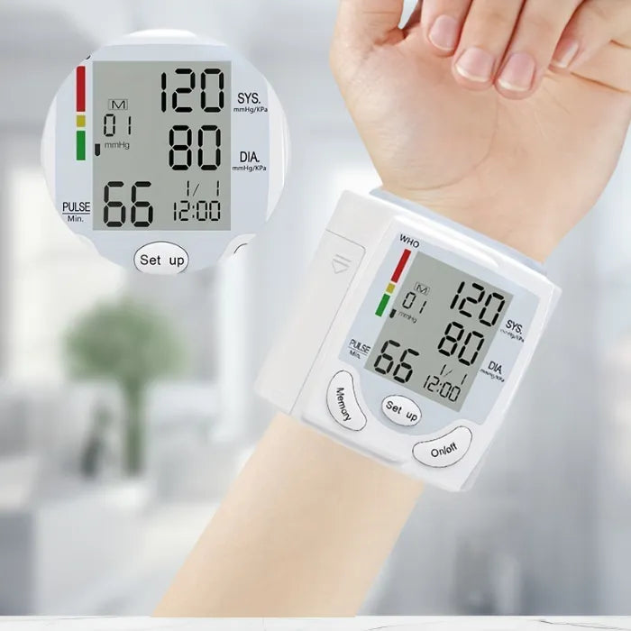 Blood pressure tester worn on wrist with close-up inset of screen showing reading details.