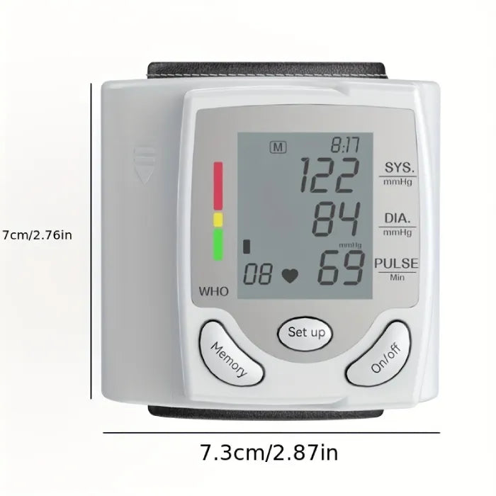 Blood pressure tester with screen on and size dimensions displayed in centimeters and inches.