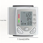 Blood pressure tester with screen on and size dimensions displayed in centimeters and inches.