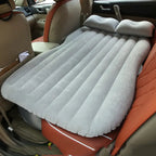 car air mattress lying across a car back seat for comfortable support on road trips