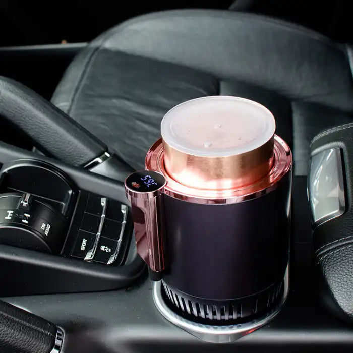 Car Heating Cooling Cup with copper container in a car’s cupholder, showing digital temperature display.