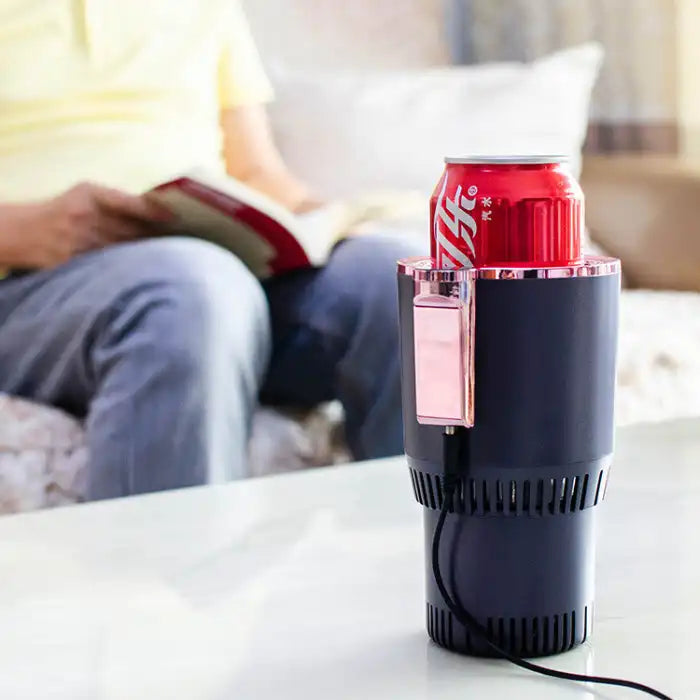 Car Heating Cooling Cup used indoors on a table, chilling a soda can while a person reads nearby.