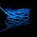 Close-up of blue LED strip light for car interiors with flexible glowing tubing on black background