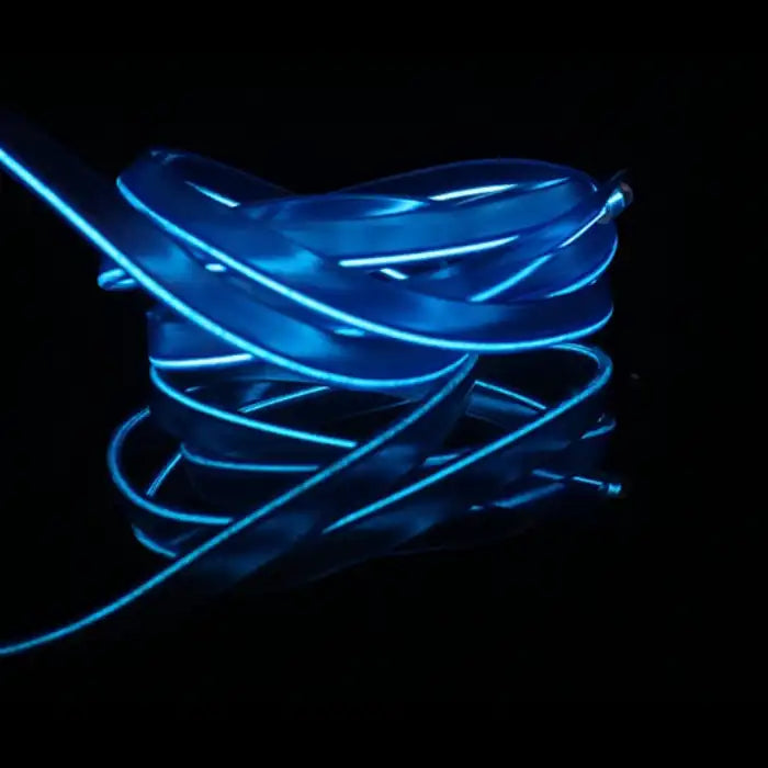 Close-up of blue LED strip light for car interiors with flexible glowing tubing on black background