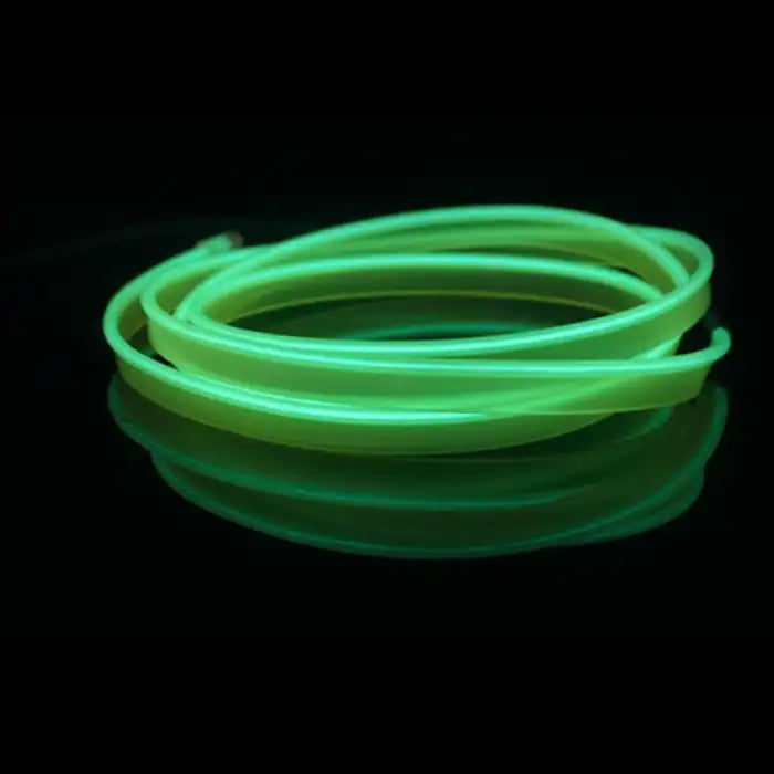 Fluorescent green car interior LED strip glowing in coil form on a reflective black surface