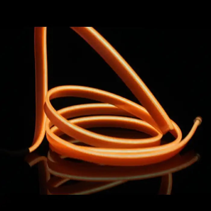 Orange LED light strip coiled on black surface, designed for car interior dashboard and trim lighting