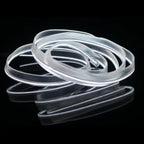 White glowing LED strip coiled for car interior lighting, shown on reflective black surface