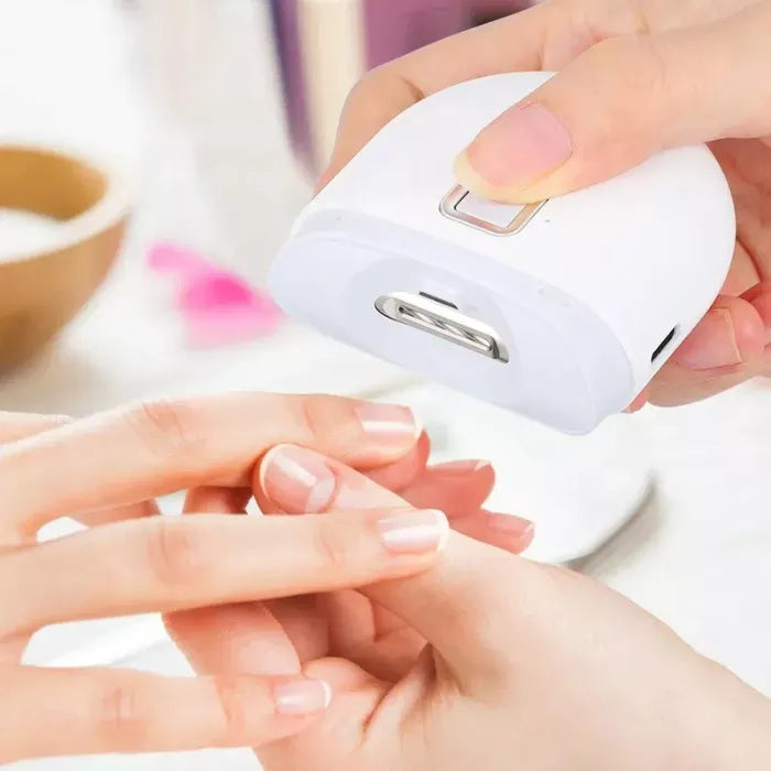 Electric baby nail trimmer safely trimming fingernails with rounded ergonomic design and button control