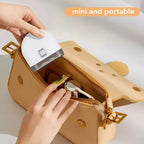 Electric baby nail trimmer shown as mini and portable, easily fitting inside a handbag.