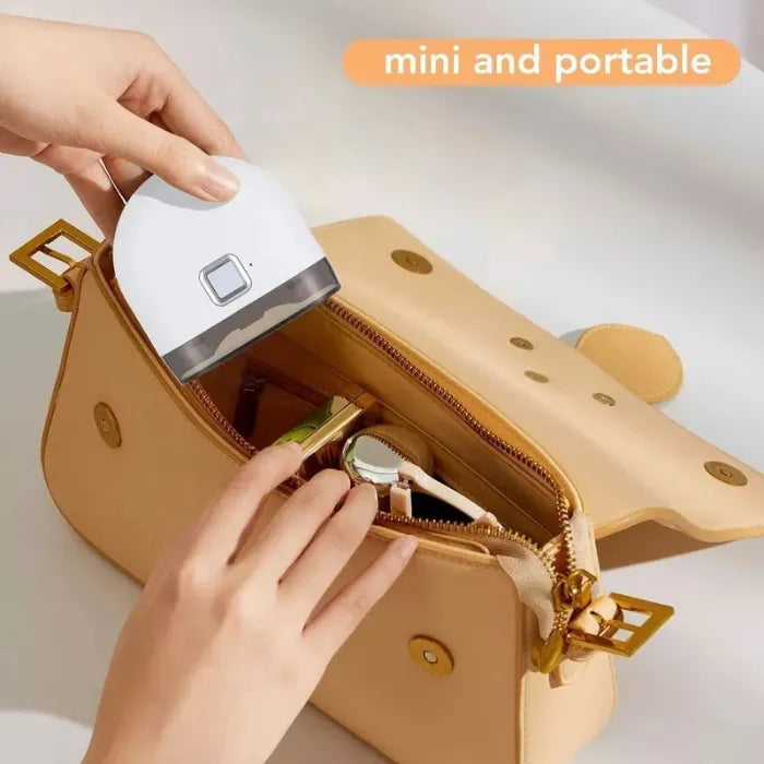 Electric baby nail trimmer shown as mini and portable, easily fitting inside a handbag.