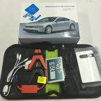 Emergency car battery jump starter kit shown with box, clamps, cables, and instruction manual.