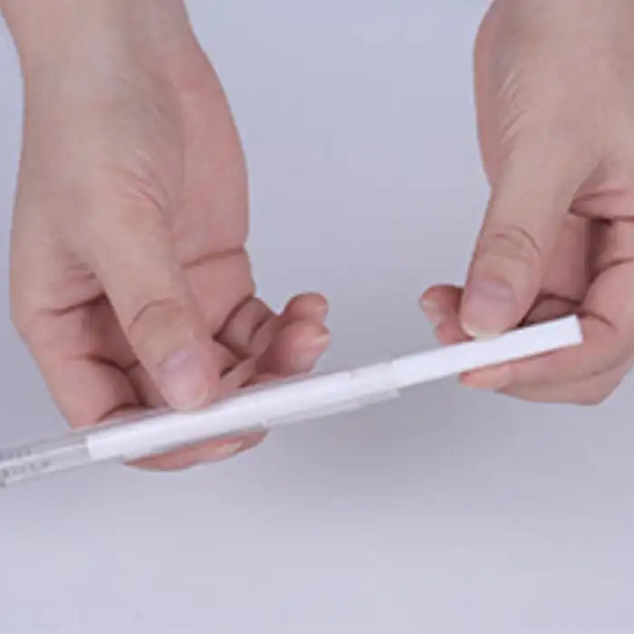 Close-up of hands holding and inserting humidifier filter rod.