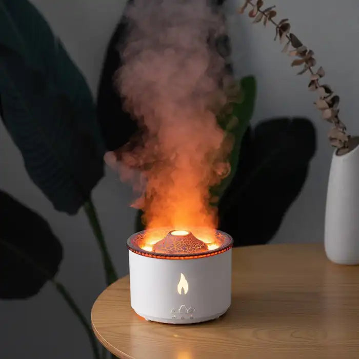 Humidifier with glowing fire effect and orange mist, creating a cozy atmosphere on wooden table