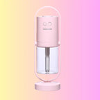 Pink pastel humidifier with visible water tank and smooth matte finish.