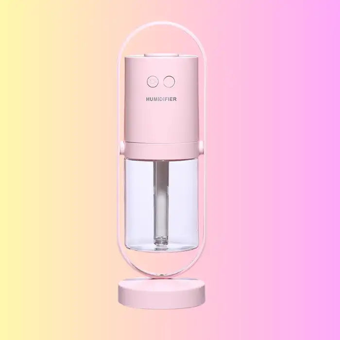 Pink pastel humidifier with visible water tank and smooth matte finish.