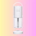 White minimalist humidifier on pastel background with transparent water tank.