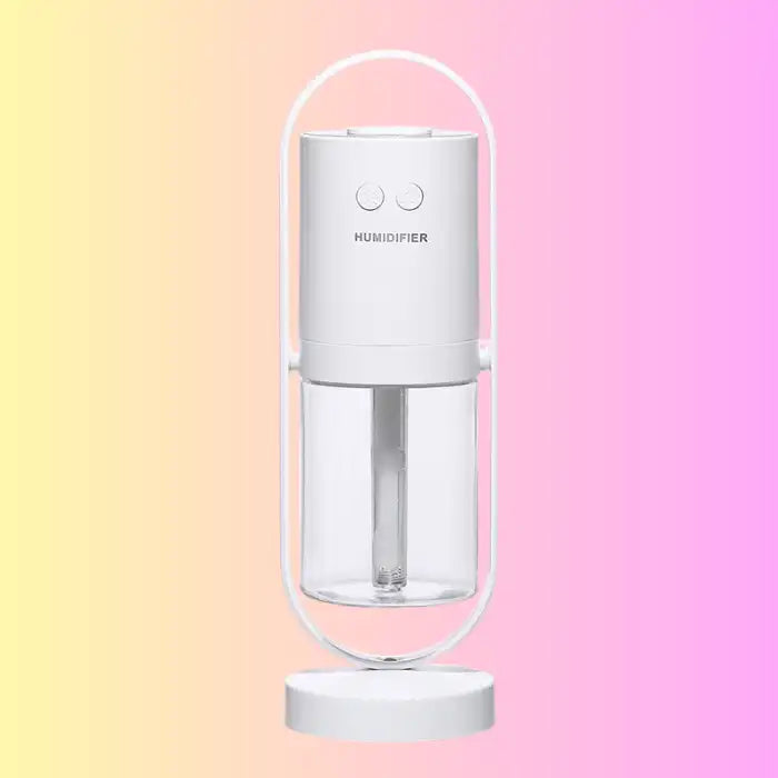 White minimalist humidifier on pastel background with transparent water tank.