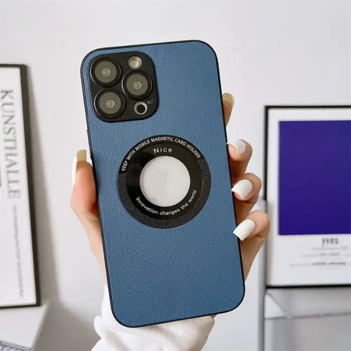 Blue leather iPhone protective case held by hand with modern interior in background