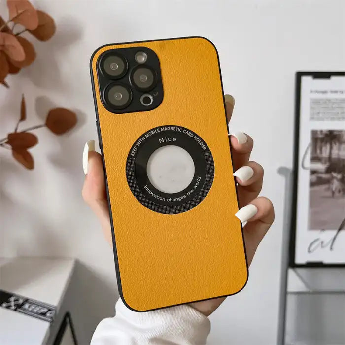 iPhone protective case in textured yellow leather held by hand with white nails