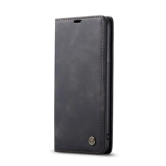Leather phone case in black with slim wallet-style flip cover and brown stitching accents.