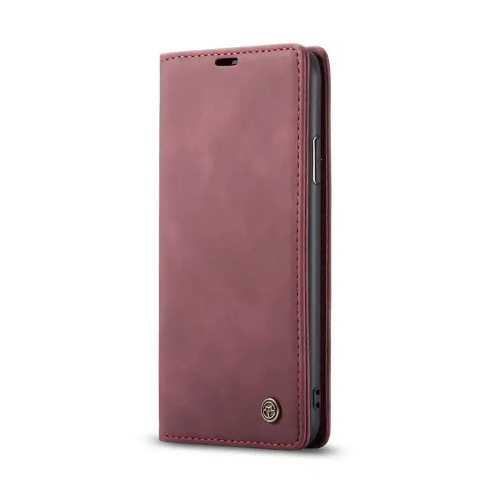 Leather phone case in maroon with contrast stitching and flip cover for elegant protection.