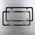 Two black license plate holder frames displayed on brushed metal background.