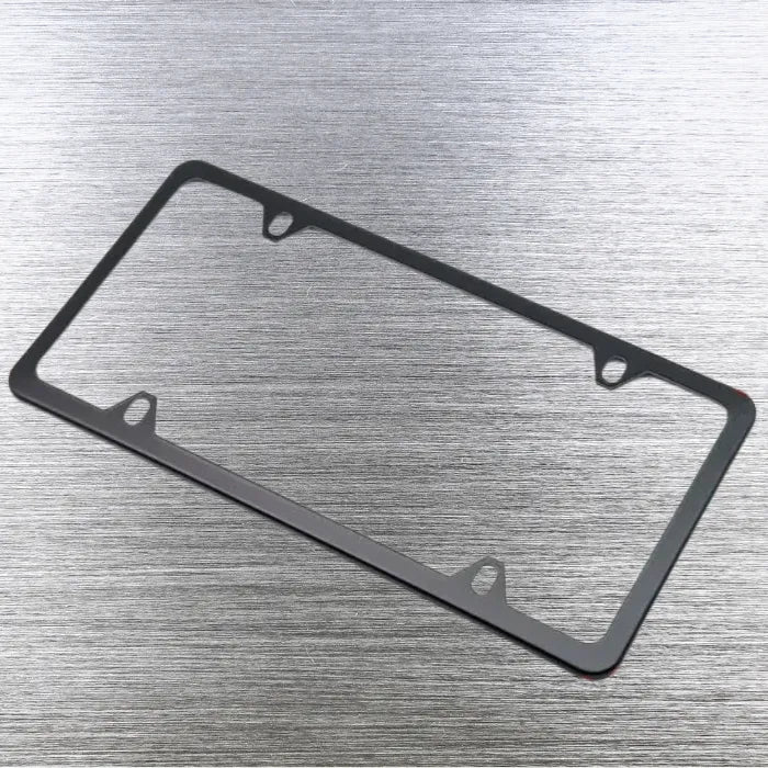 Single black license plate holder frame angled on brushed steel surface.