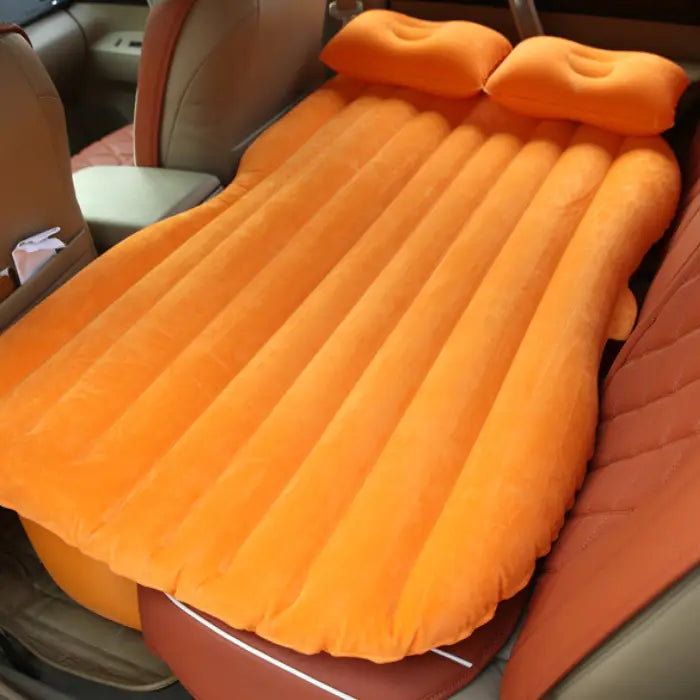  Orange car air mattress fits efficiently in back seat with pillows for comfortable travel sleeping