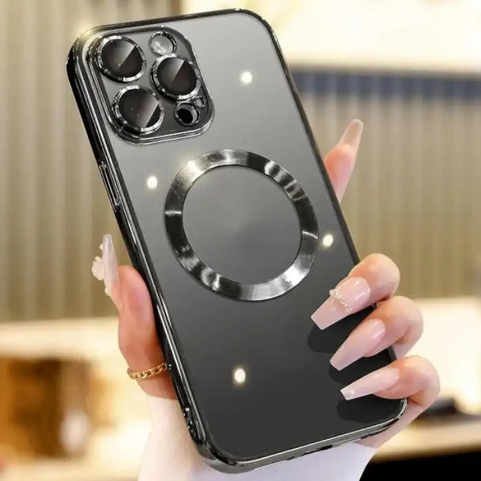 Phone case with black glossy finish and metallic magnetic ring, held in hand with manicured nails