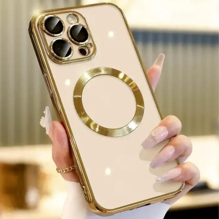 Phone case in gold with reflective mirror finish and circular ring, held by hand with light pink nails