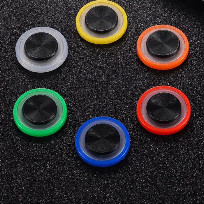 Assorted Phone Joystick colors placed on a black table surface for display