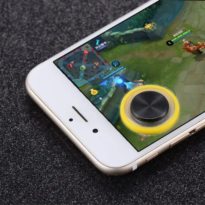 Yellow Phone Joystick attached to smartphone screen during active mobile gameplay