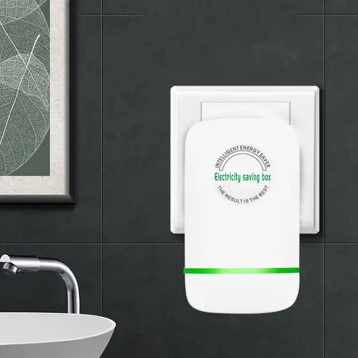 Power Saver Module device plugged into outlet near bathroom sink with modern décor.
