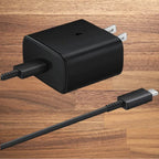 Rapid charging black USB-C adapter with cable on wooden background.