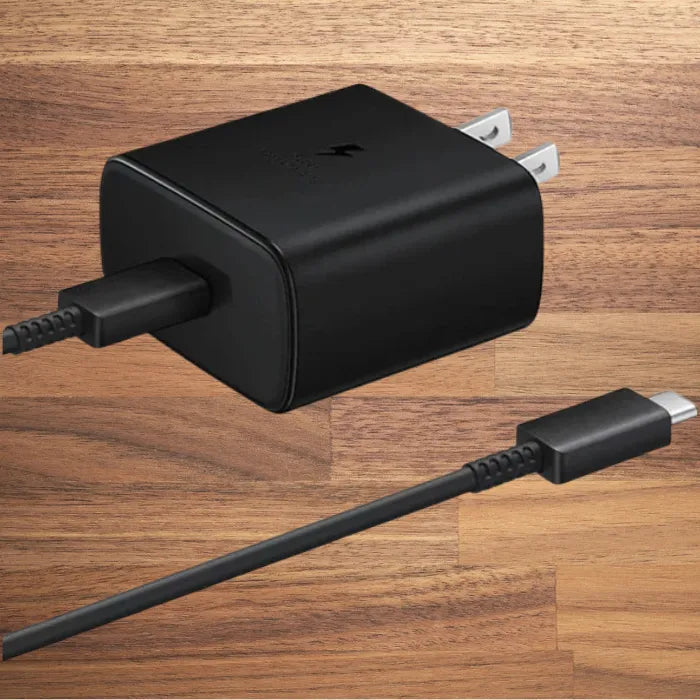 Rapid charging black USB-C adapter with cable on wooden background.