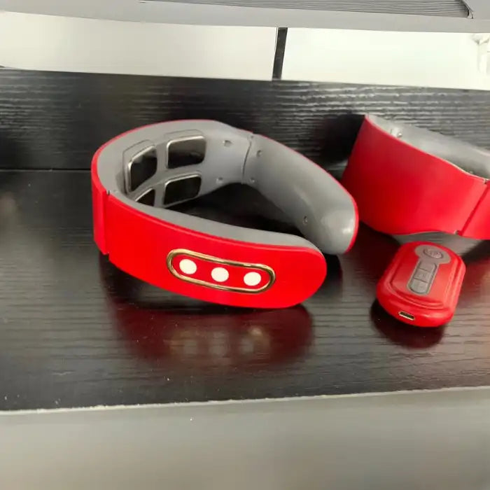 Red Neck Massager shown with remote control on shelf, featuring multiple electrode pads.