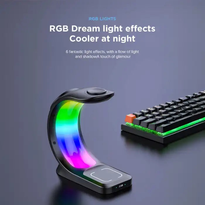 RGB wireless charging station next to keyboard glowing with rainbow lights, empty stand visible