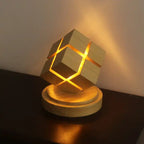 Rubix cube night light with battery power glowing warmly on dark wooden surface