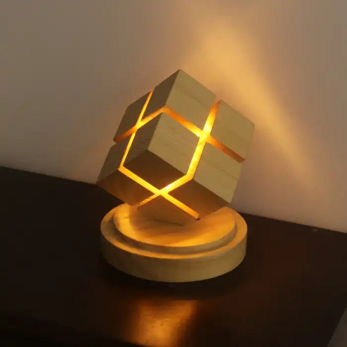 Rubix cube night light with battery power glowing warmly on dark wooden surface