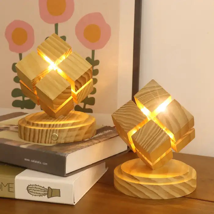 Rubix cube night light with battery power displayed on stacked books with warm glow lighting