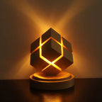 Rubix cube night light with battery power casting ambient golden glow on wall and table surface