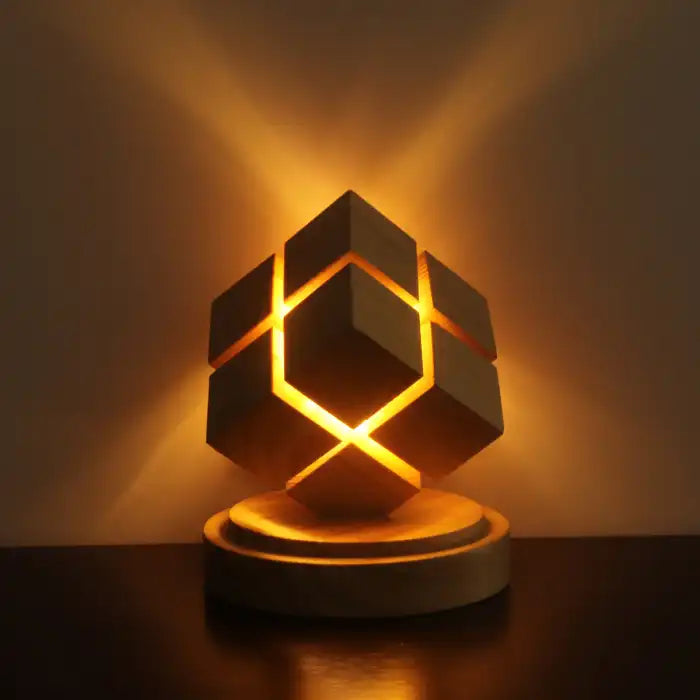 Rubix cube night light with battery power casting ambient golden glow on wall and table surface