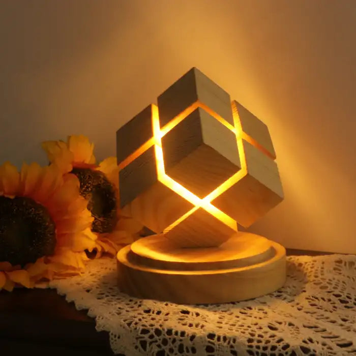 Rubix cube night light with battery power glowing near sunflowers on crocheted cloth