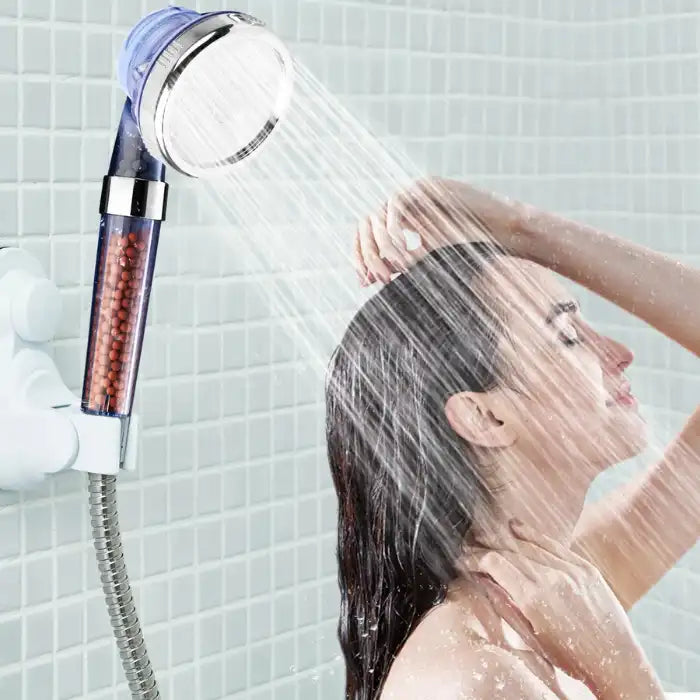 Shower Head Filtration in use by a woman under rainfall mode showing strong flow and full hair coverage