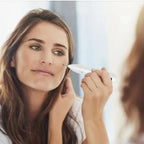 Skin Tag Remover pen being used by a woman to target a dark spot on her cheek.