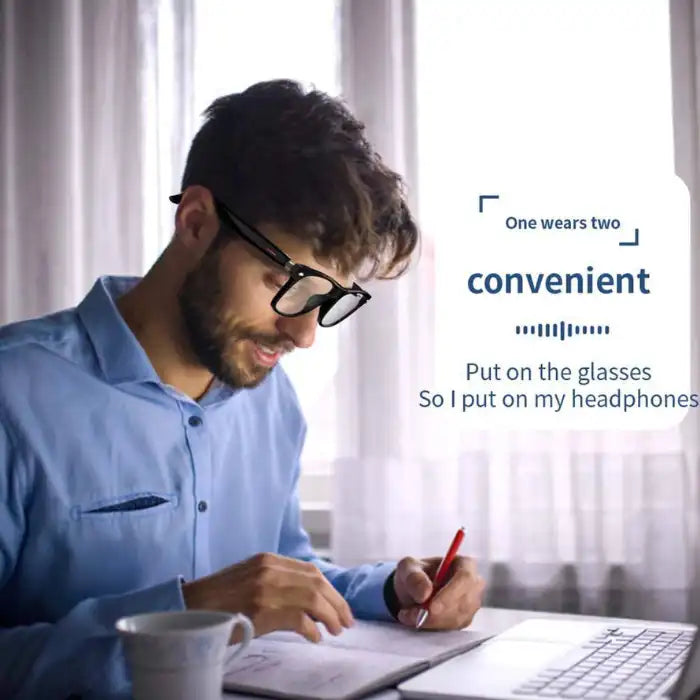 Smart Glasses worn by man working on laptop with built-in headphones for music and calls