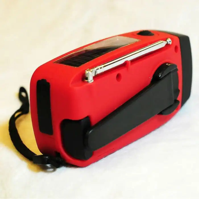 Survival Radio with folded crank handle and visible solar panel, shown from back side.